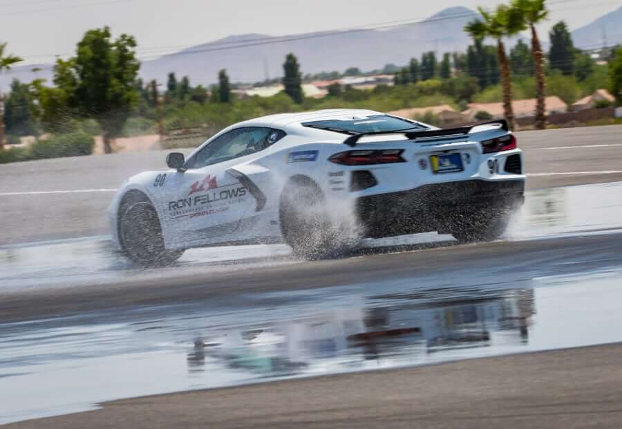 Ron Fellows Performance Driving School controlled skidding on wet pavement